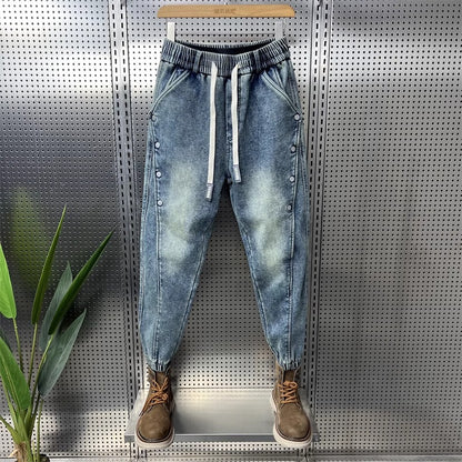 Mens Washed Denim Jeans With A Vintage Design, Featuring Button Detailing And A Tapered Leg